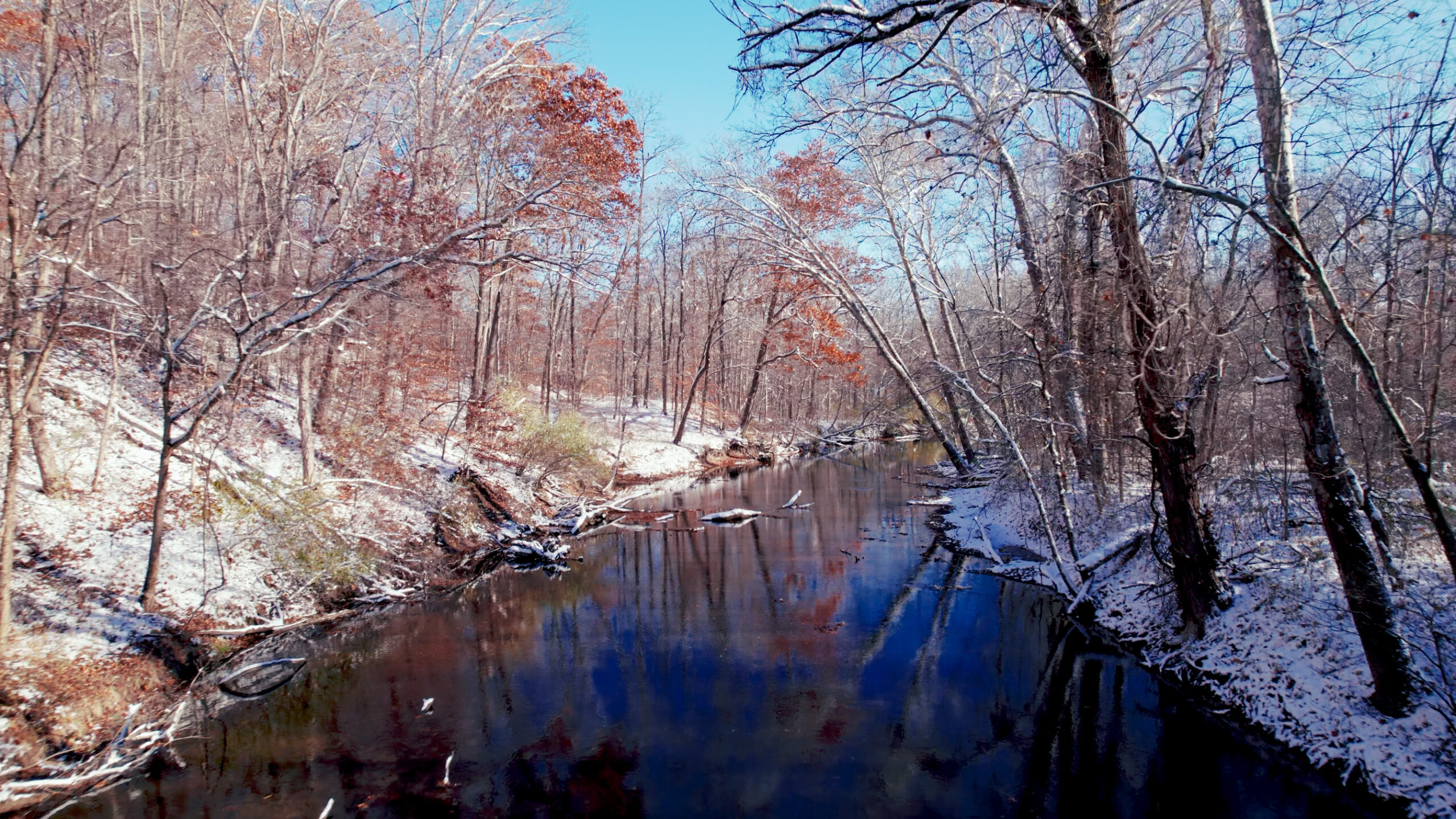 snowy view of Cedar Creek at the Tom & Jane Dustin Nature Preserve
